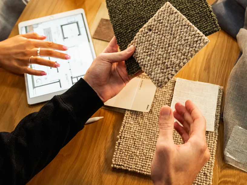 Woman working on rug samples