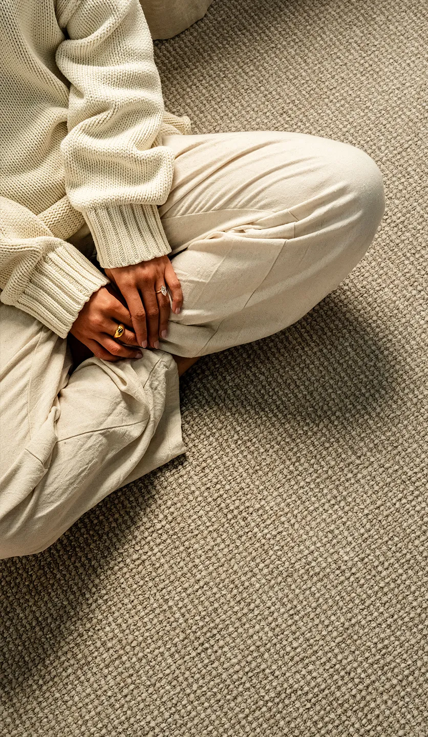 woman sitting on rug