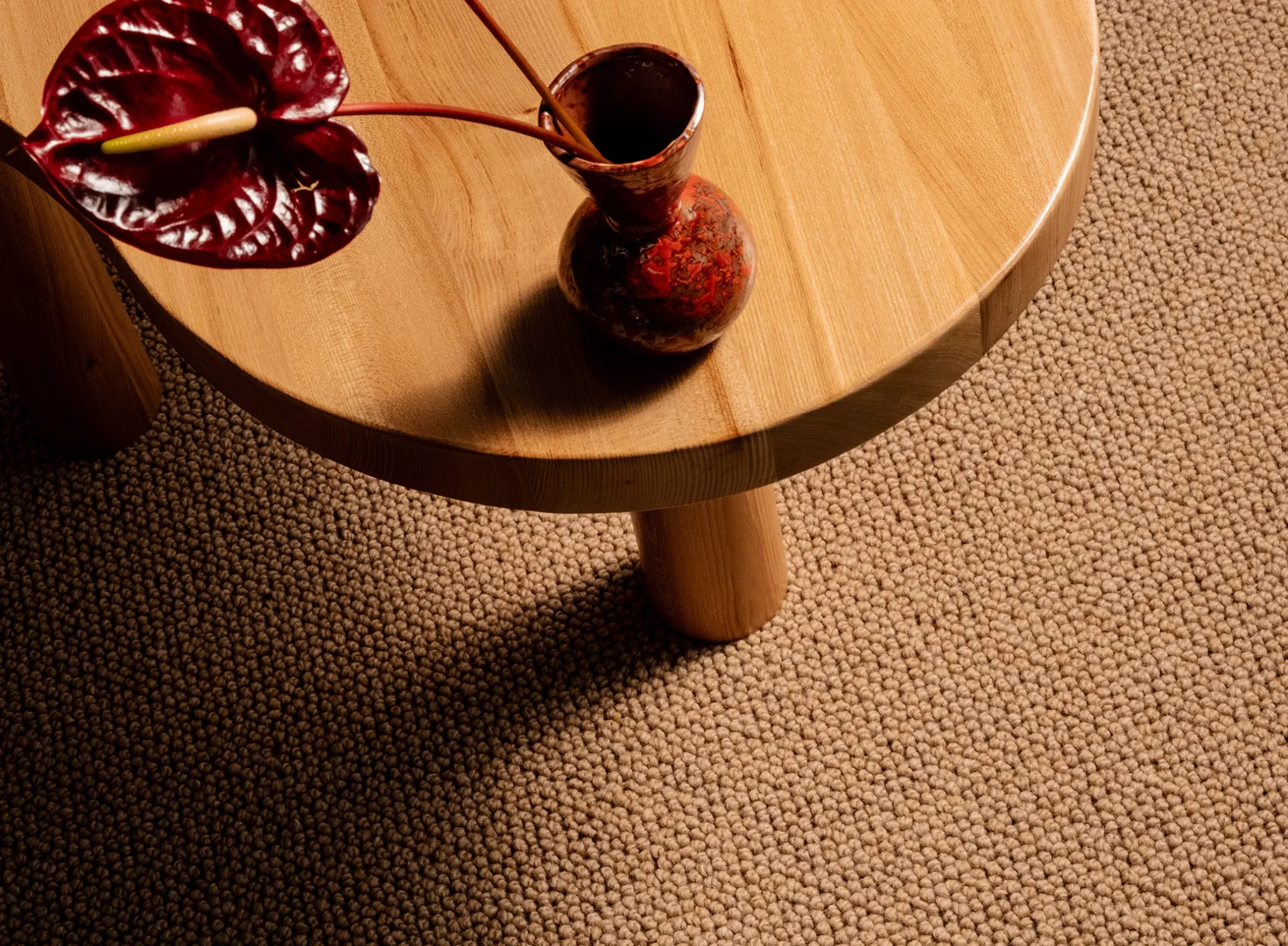 Table on top of Wool Rug